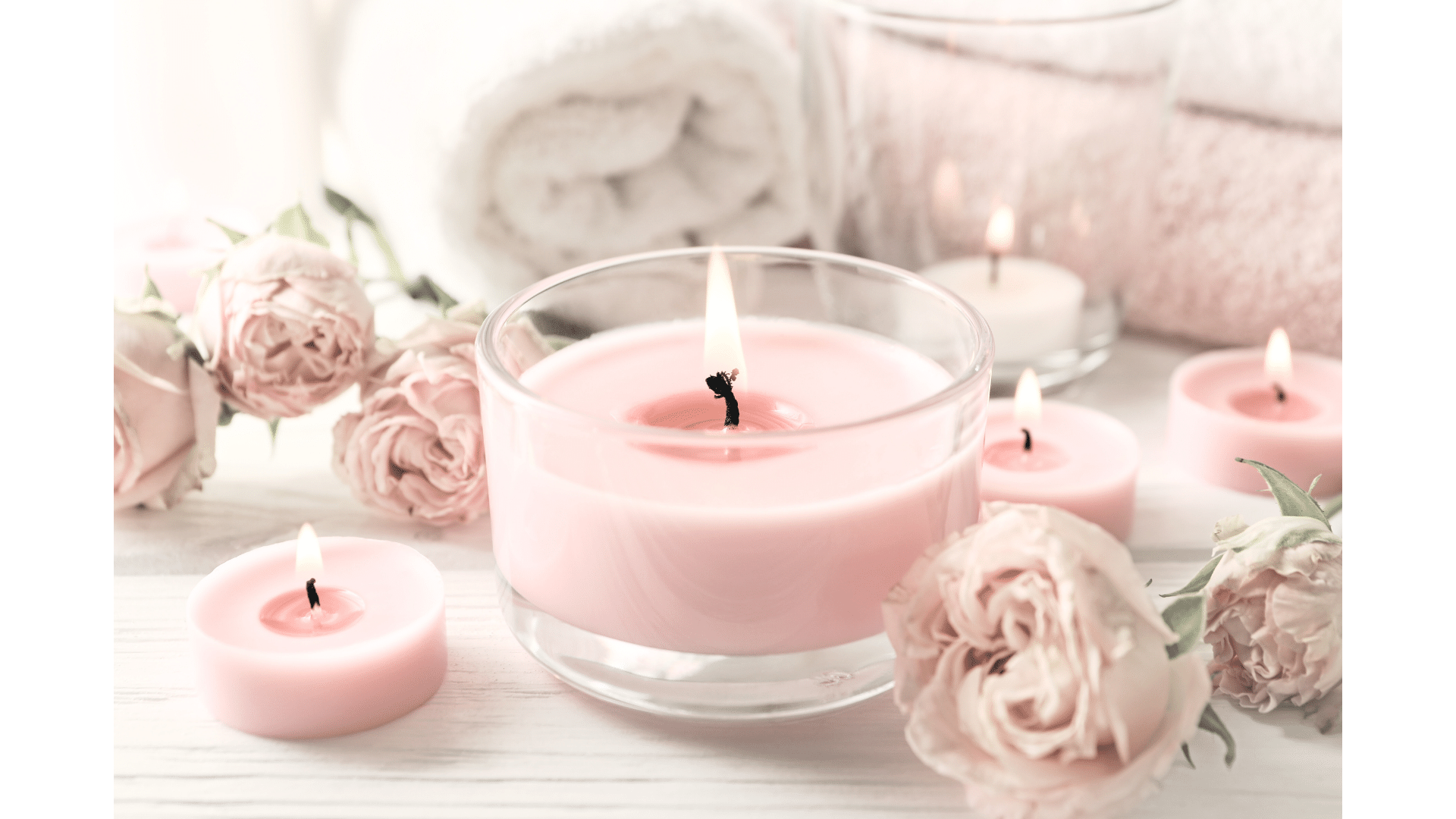 Pink aromatherapy candles with rose petals enhancing a serene ambiance, perfect for a scents guide.