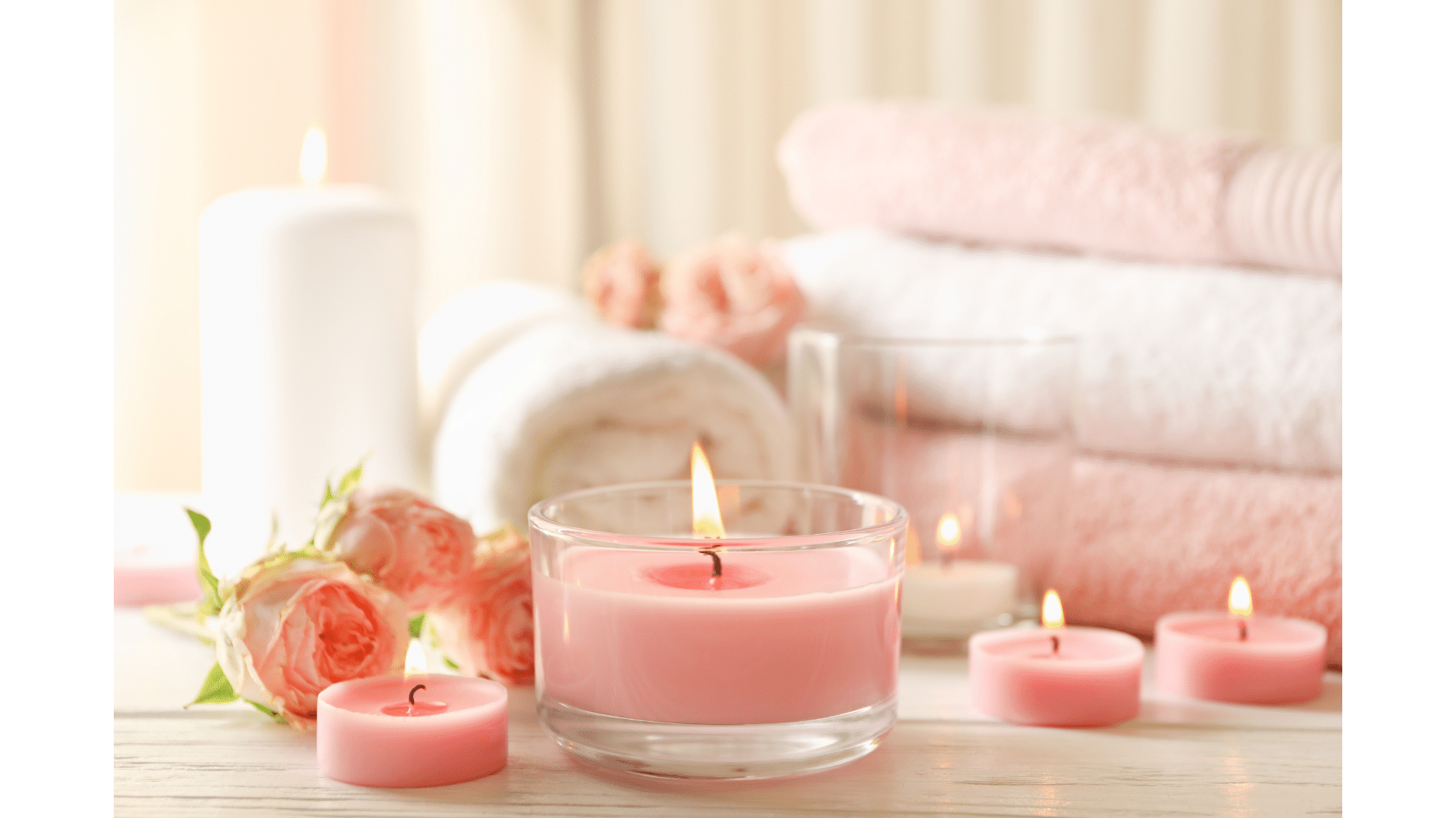 Therapeutic candle aromas: Lit candles with pink wax, creating a relaxing ambience.